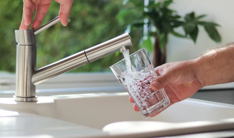 Filling a glass with water from a kitchen tap