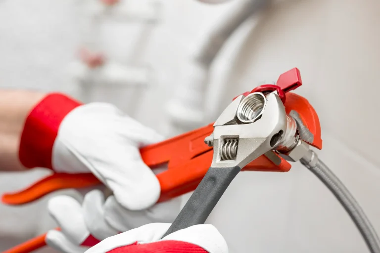 Professional pipe tightening with spanners for secure plumbing connections